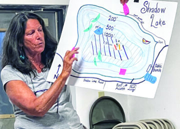 Jennifer Andrews, president of the Shadow Lake Association, holds a map showing where wake boats might be allowed.
