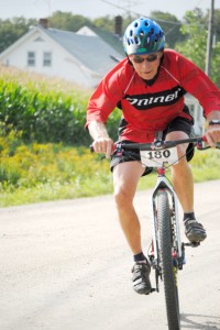 Dave Lafoe of Norton plays a game of chicken with a photographer during the first leg of the Dirty 40 cycling race Saturday.  As the oldest listed participant in the race at age 72, Mr. Lafoe finished with a respectable time of 4:41:31.
