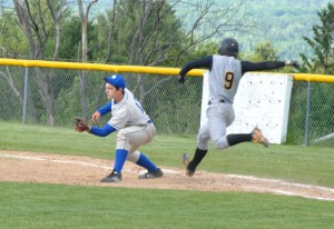 Solid defense and hot hitting have been key elements in Lake Region's late season surge.  Here Ranger Sam Barbeau snags the throw as Harwood Highlander Matthew Fischer charges down the first base path. 