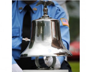 This bell from the Orleans Volunteer Fire Department's 1938 International was chimed in memory of the Vermont soldiers who have given their lives in service to their country in the War on Terror.  Fire department member Justin Peart rang the bell after each name was read aloud by members of American Legion Orleans Post #23 at Monday's Memorial Day observances.  Photo by Richard Creaser