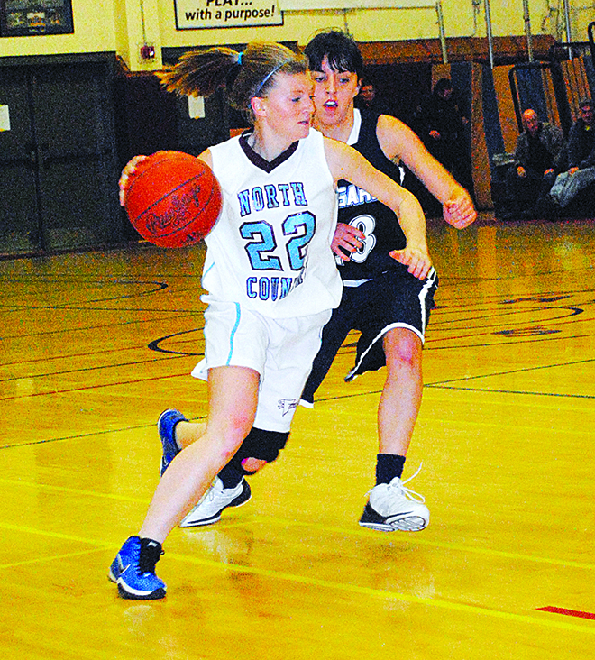 Lady Falcon Ashley Robishaw-Morin demonstrates the speed of the North Country squad as she bolts past Mount Mansfield defender Wynne Poleman.  Photo by Richard Creaser