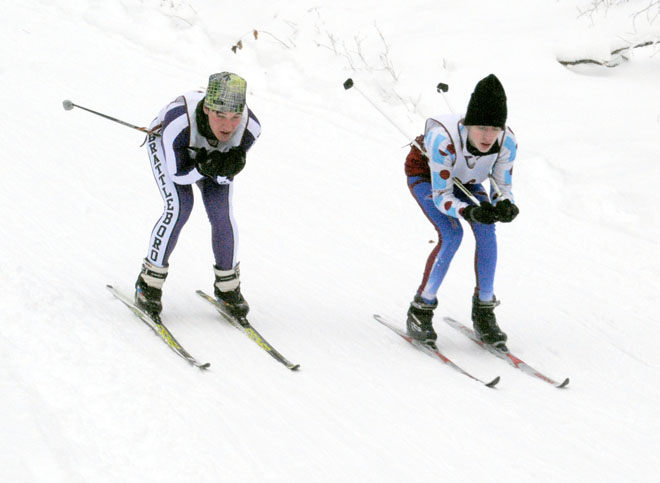 North Country's Sam Brunette (right) moves to pass Brattleboro Union High's Oliver Pomanzi in boys' varsity Nordic ski action on December 28.  Brunette's time of 20:29 was tops among the Falcons on the day. Photo by Richard Creaser