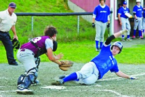Ethan Willey of Glover slides into base during the game on July 12 versus the Lyndon All-Stars.  Minding the base is Levi Daniels.  Photo by Walter Earle