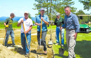 Lieutenant Governor Phil Scott (far right) listens to Newport Country Club Superintendent Ryan McCaffrey (center) explain how to clear a sand bunker as his co-workers for the day get started.  Pictured, from left, are Dylan Bohlman, Denis Comeau, Mr. McCaffrey, Laurent Leblanc Jr. and Lieutenant Governor Scott.