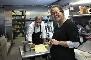 Amy Wan (right) and chef Mike Wheeler go over the night's dinner menu at 100 North Restaurant Saturday.