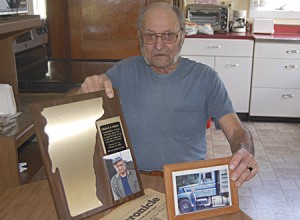 Bill Peters' children recently gave him a plaque, honoring him for possibly being the oldest man in Vermont who still holds a CDL.  He's 95, and was a longtime road commissioner in Albany.   Photo by Tena Starr  