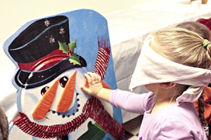 Nevaeh Wilczek, dizzy and blindfolded, makes her third attempt to place the carrot where the snowman's nose ought to be.