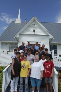A church group came all the way from New York to renovate the Holland Community Church last week.  Here the group poses in front of the church they had been working on all week.  They were in the process of finishing the reinstallation of the vinyl siding before returning to their homes on Saturday.  Pictured here, in the top row, from left to right, are Bob Zuber, Jason Newell, and Bill Weyer.  In the next row, from left to right, are Tino Almodovar, Aaron Abrahamsen, wearing a black shirt and a crucifix, Justin Zuber, and Ed Conti.  In the next row down, are Joshua Harvey, who is wearing a spotted shirt, James Houston, Lori Buck, with braids in her hair, and Vincent Pappalardo.  In the next row, from left to right, are Joanne Parzuchowski, with glasses on her head, Ed Parzuchowski, Pat Kelly, and Tiffany Hervas.  In the front row, are Amy Ciofrone, Hope Harvey, Suzanne Phinkham, and Jared Parzuchowski.  Harry Kelly and Lou Samaritano, who aren’t in the picture, were also part of the group.  Photos by Nathalie Gagnon-Joseph