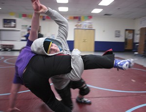 Josh Roberts slams teammate Logan Dolloff to the mat.  Photos by David Dudley
