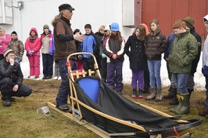 Ken Haggett of Peace Pups Dogsledding brought 20 dogs and two dogsleds to Albany Community School last week. Here he tells students about his dogs and his equipment.