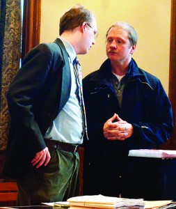Derick Niles, left, consults with his lawyer, Christopher Davis, at a court hearing in Newport in April 2104.  Photo by Joseph Gresser
