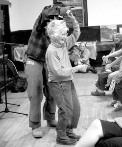 As Lila Winstead and Rose Friedman favored the crowd at the 2014 edition of the Glover Talent Show with their rendition of the “Log Driver’s Waltz,” a masked logger made his appearance from the back of the hall.  After presenting the evening’s object of his affections with gifts, including a chicken hat, the logger persuaded Lucy Smith to take to the floor for a few elegant steps.  Reliable sources hint the logger was, in reality, Maura Gahan.  The annual talent show is a benefit for the Glover Public Library.  Photo by Joseph Gresser