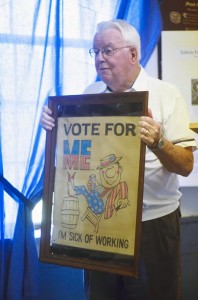 Former state Senator Kermit Smith shows a poster that he claims he will use should he ever run for office again. 
