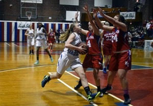 Molly Horton drives to the hoop in the face of the resolute Mill River defense.   Photos by Joseph Gresser
