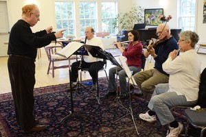Working with what was two-thirds of his orchestra in April of 2011, Mr. Michelli leads a rehearsal at The First Universalist Parish of Derby Line.  Following his lead, from left to right, are Chris Maginniss, Lisa C. Erwin, Paul Gavin, and Susan Brassett.  Photo by Joseph Gresser
