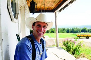 Neal Perry, pictured here, and his wife, Rebekah, are the owners of a 134-acre farm in Brownington.  He sits on his porch as he discusses plans to sell the property to the Vermont Land Trust.  That organization, in turn, plans to sell the land to a new farmer at a price that will allow him or her to keep it in agriculture.  Photos by Joseph Gresser