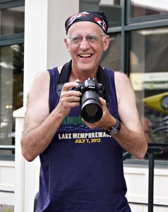 Phil White photographs swimmers at the 2012 Aquafest parade on Newport’s Main Street.   Photo by Joseph Gresser