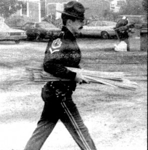 In this Chronicle file photo, a Vermont state trooper carries a bundle of wooden rods out of a restaurant owned by the Island Pond community on June 22, 1984.