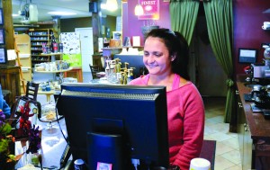 Megan Waagen rings up a purchase at the Woodknot Bookshop.  By adding a café, Ms. Waagen and her husband have created a gathering spot in Newport and built a group of loyal customers.  