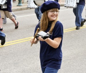 An enthusiastic group of musicians from Newport City Elementary School marches down Main Street on Memorial Day.  Pictured is Victoria Young playing a cowbell.  Photo by Joseph Gresser