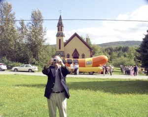 One of Rian’s happiest moments was the wedding of his daughter Dorigen to Jon Hofmann.  To celebrate, Rian arranged for the Oscar Meyer Wienermobile to show up at the Stannard church.  Dr. Hofmann drove the classic rig as he worked his way through college.  My only photograph of Rian was of him making a self-portrait with the Wienermobile in the background.  Photo by Joseph Gresser