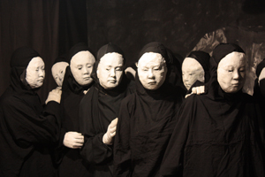 Performers in Fire line up to mourn.  The mold for some of the masks was made in the 1960s, when Peter Schumann lived in New York.