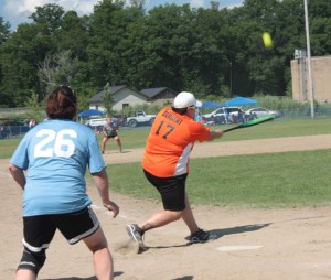 Bridget Sargent hits a hard drive to left field in Paquette's victory over Burnett's Scrap Metal in the women's ASA softball tournament Sunday in Newport. Also pictured is Veronica Sargent of Burnett's. Photo by David Dudley 