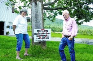 Shirley and Don Nelson flank a sign that is common in their neighborhood.  Photo by Chris Braithwaite